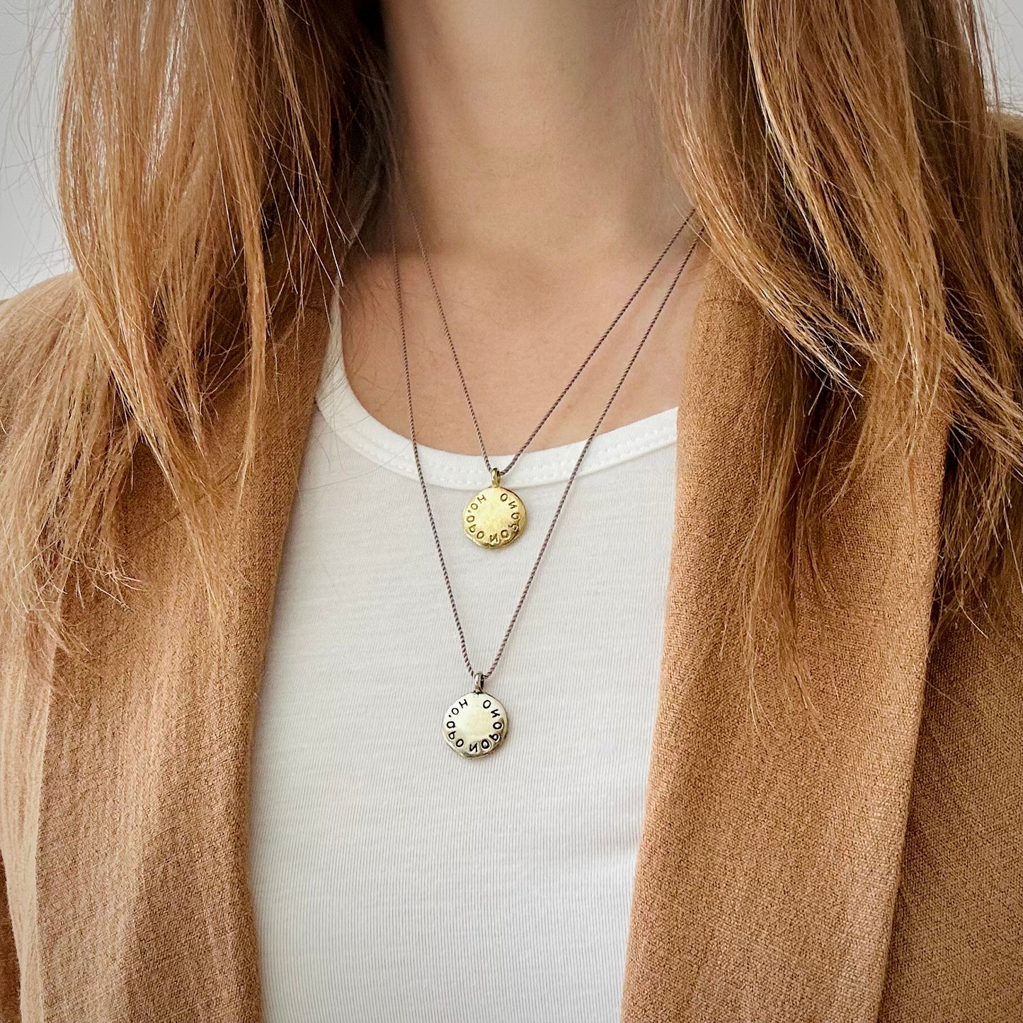 layered necklaces one silver one gold coin