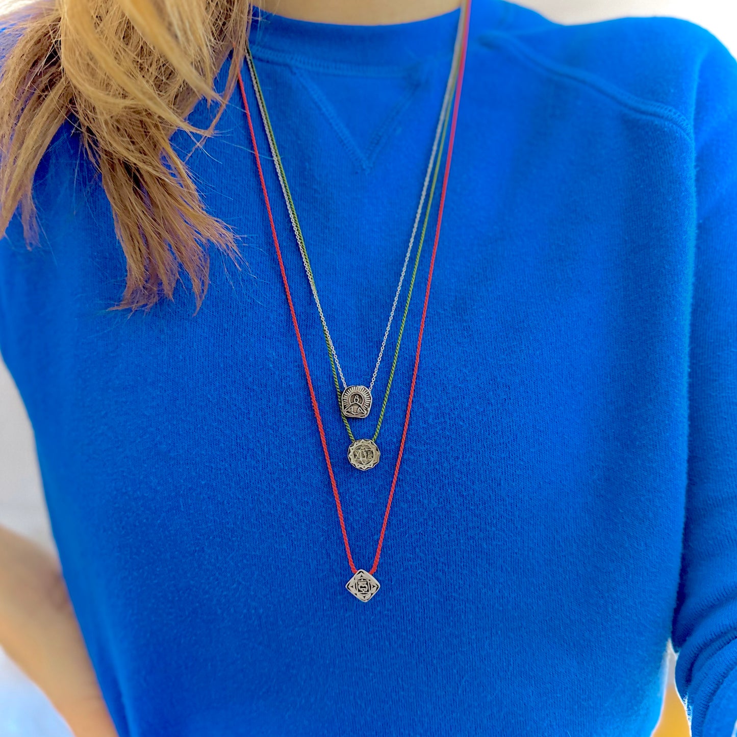 heart chakra on green silk necklace root chakra on red silk and seat of the soul on white silk